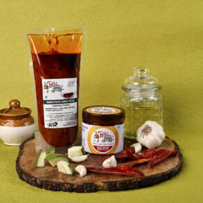 Two packaging options: PET jar and pouch of Mashed Mango Garlic Pickle with accompanying garlic, mango and dry chilies